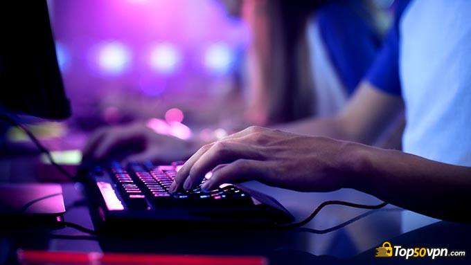 Best VPN for gaming: a guy playing a computer game, typing a keyboard.