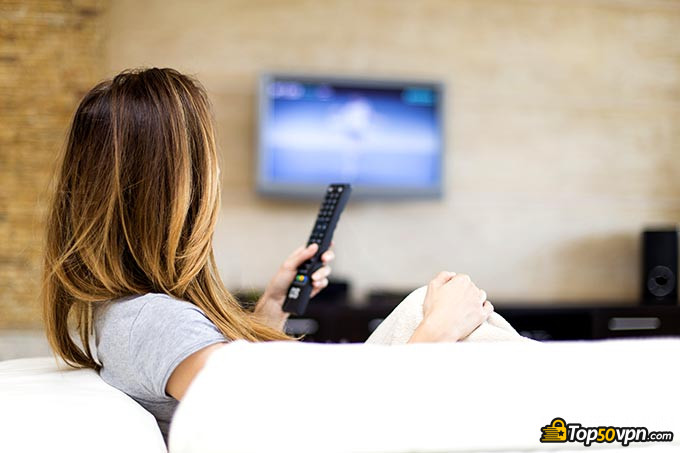 Best VPN for Kodi: a woman watching TV.