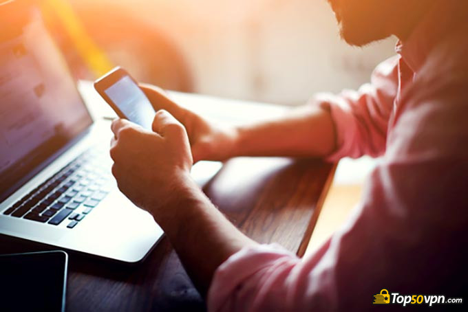 Types of VPN: a man typing something on his phone.